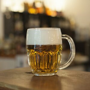 A mug of beer on a bar.
