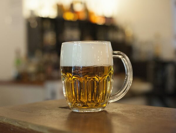 A mug of beer on a bar.
